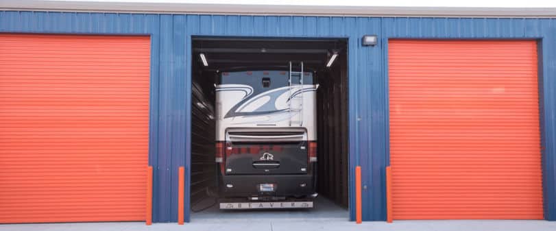 A large RV parked in an enclosed storage unit