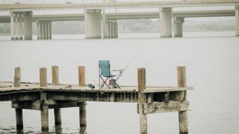 A chair and fishing pole on a dock at lake ray hubbard