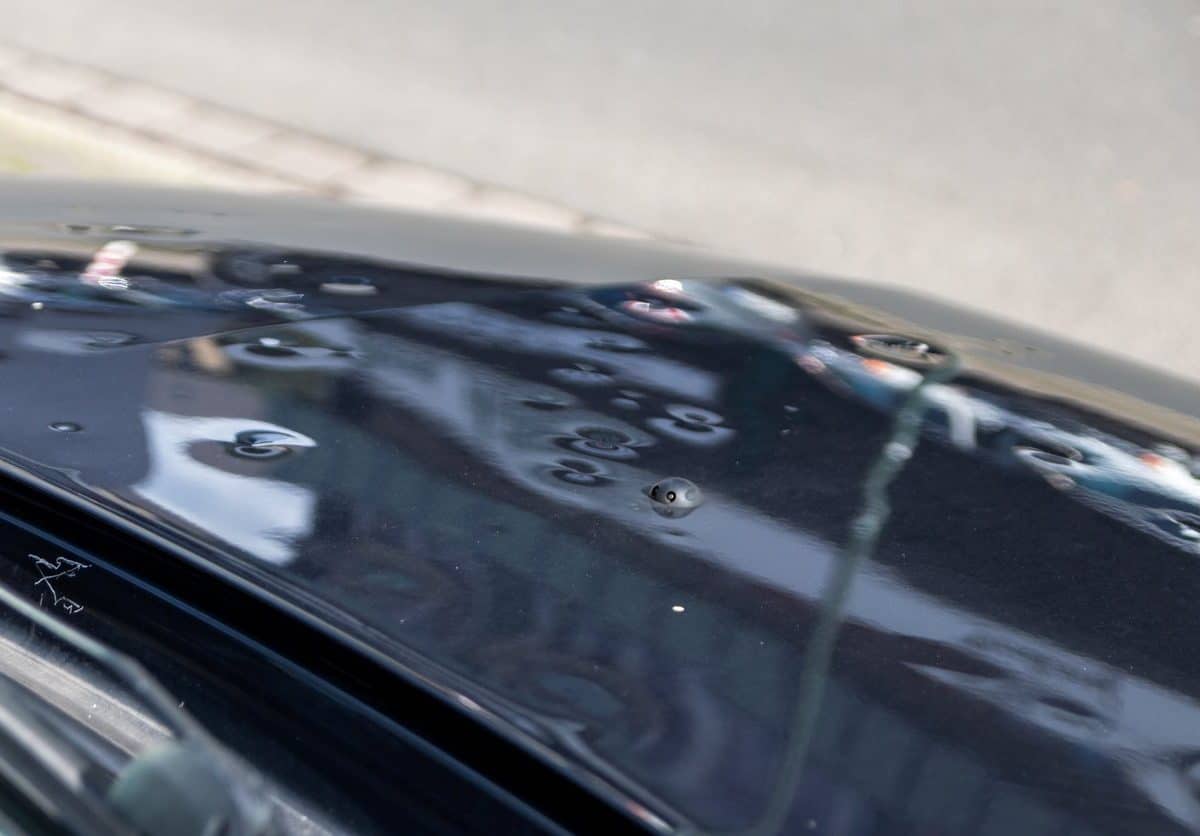 A car with hail damage on the roof