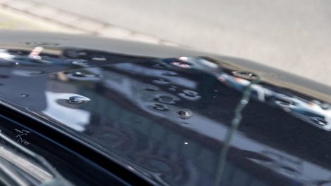 A car with hail damage on the roof