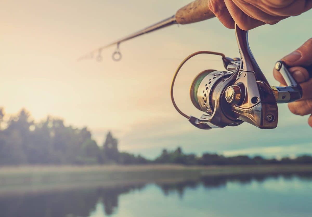 A fishing pole being used during sunset