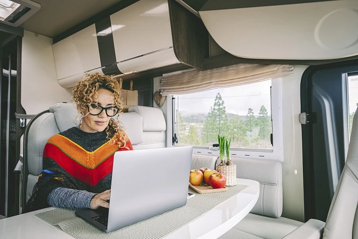A digital nomad working from their laptop in an RV.