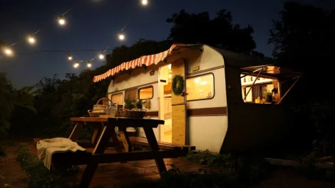 RV at night with lights and table out front