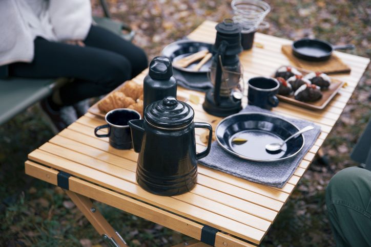 A top view of two people having breakfast at a campsite.